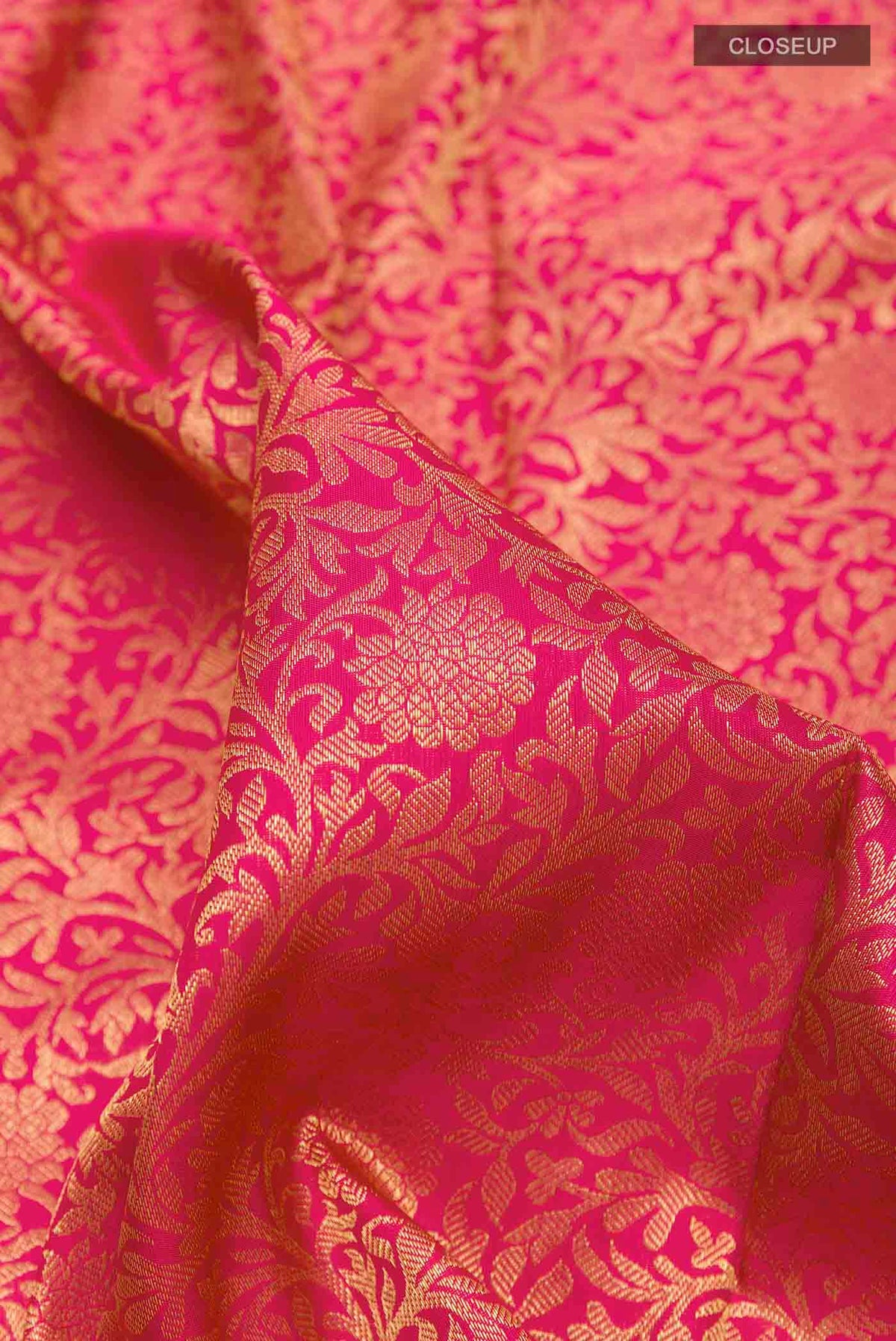 Close up of Pure Silk Pure Zari Pink Kanchipuram Saree with Zari Brocade on the body and Zari Border displaying folds