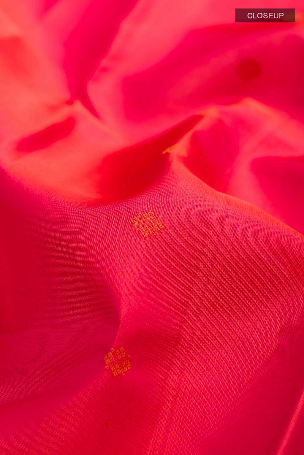 Close up of Pink with Orange Color Kanchipuram Silk Saree with Thread Butta on the body and Zari And Thread Border displaying folds