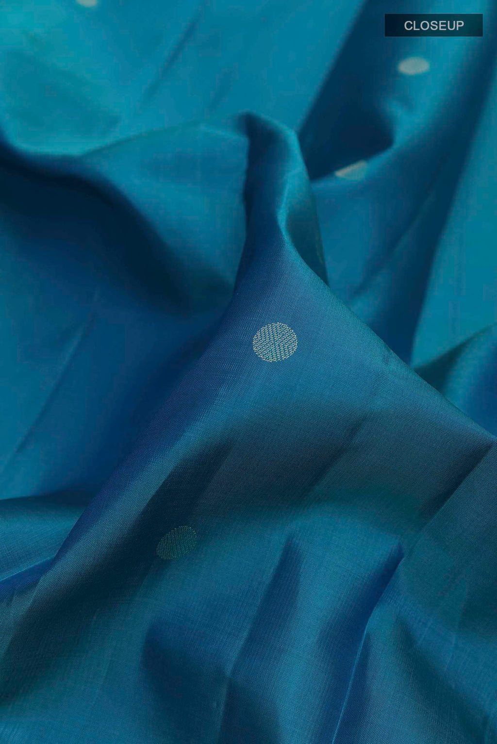 Close up of Blue Kanchipuram Silk Saree with Zari Butta on the body and Zari Border displaying folds