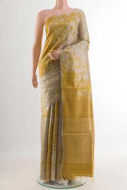 Beige Tussar Silk Saree with Printed design on the body and Thin Zari Line.  displayed on a mannequin