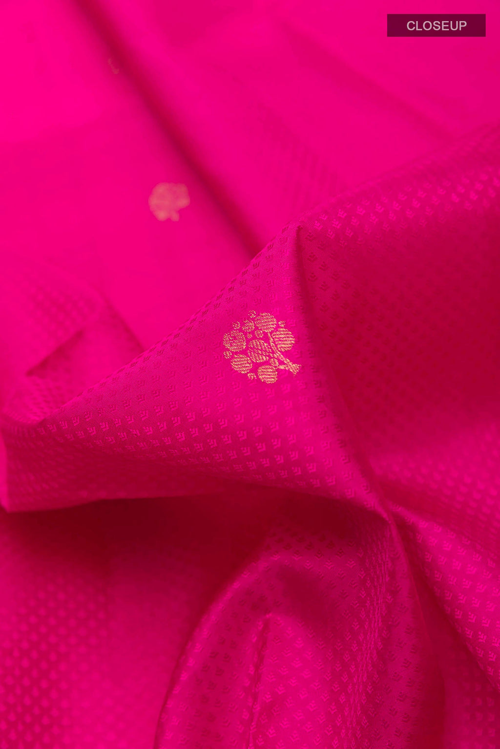Close up of Pink Kanchipuram Silk Saree with Jacquard With Zari Butta on the body and Zari Border displaying folds