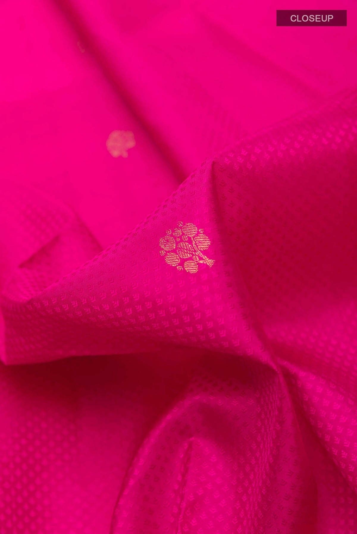 Close up of Pink Kanchipuram Silk Saree with Jacquard With Zari Butta on the body and Zari Border displaying folds