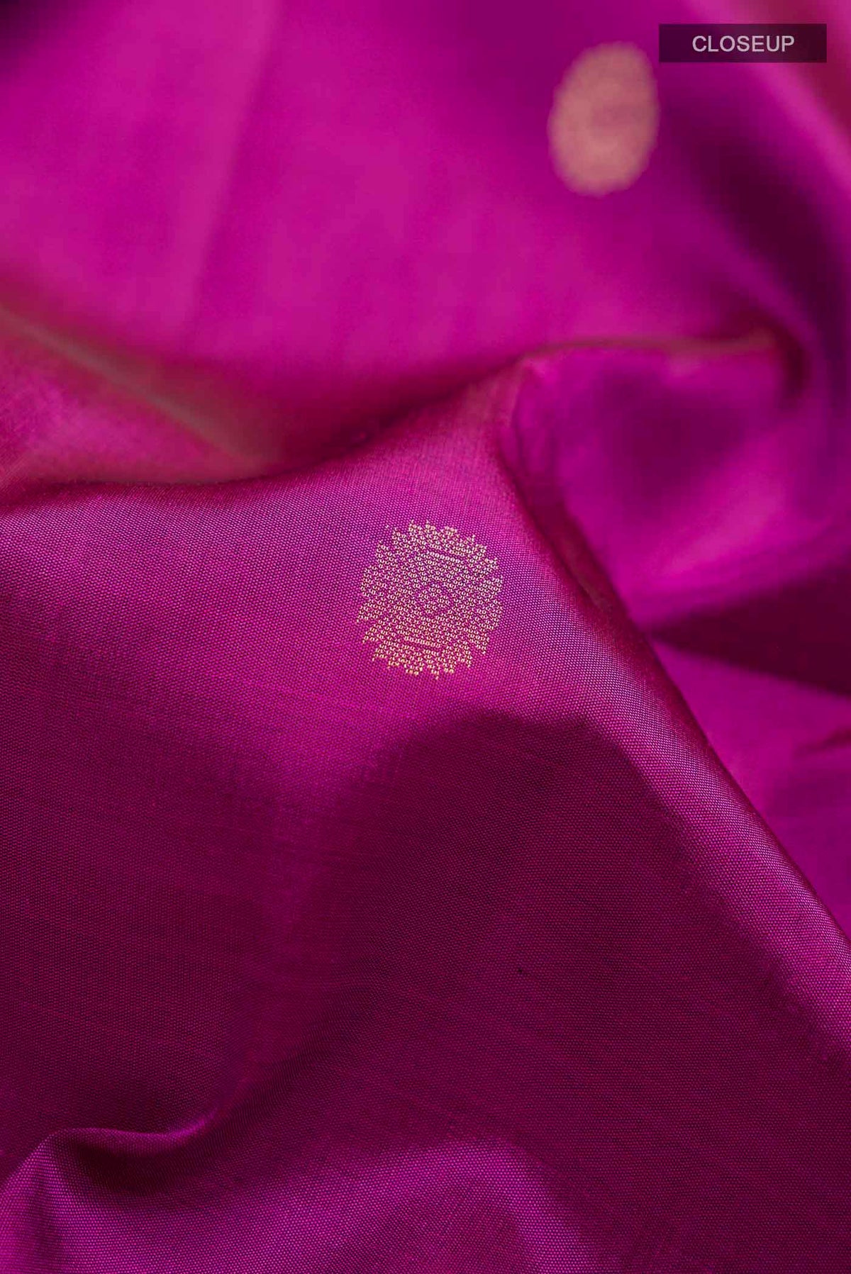 Close up of Purple Soft Silk Saree with Zari Butta on the body and Zari Border displaying folds