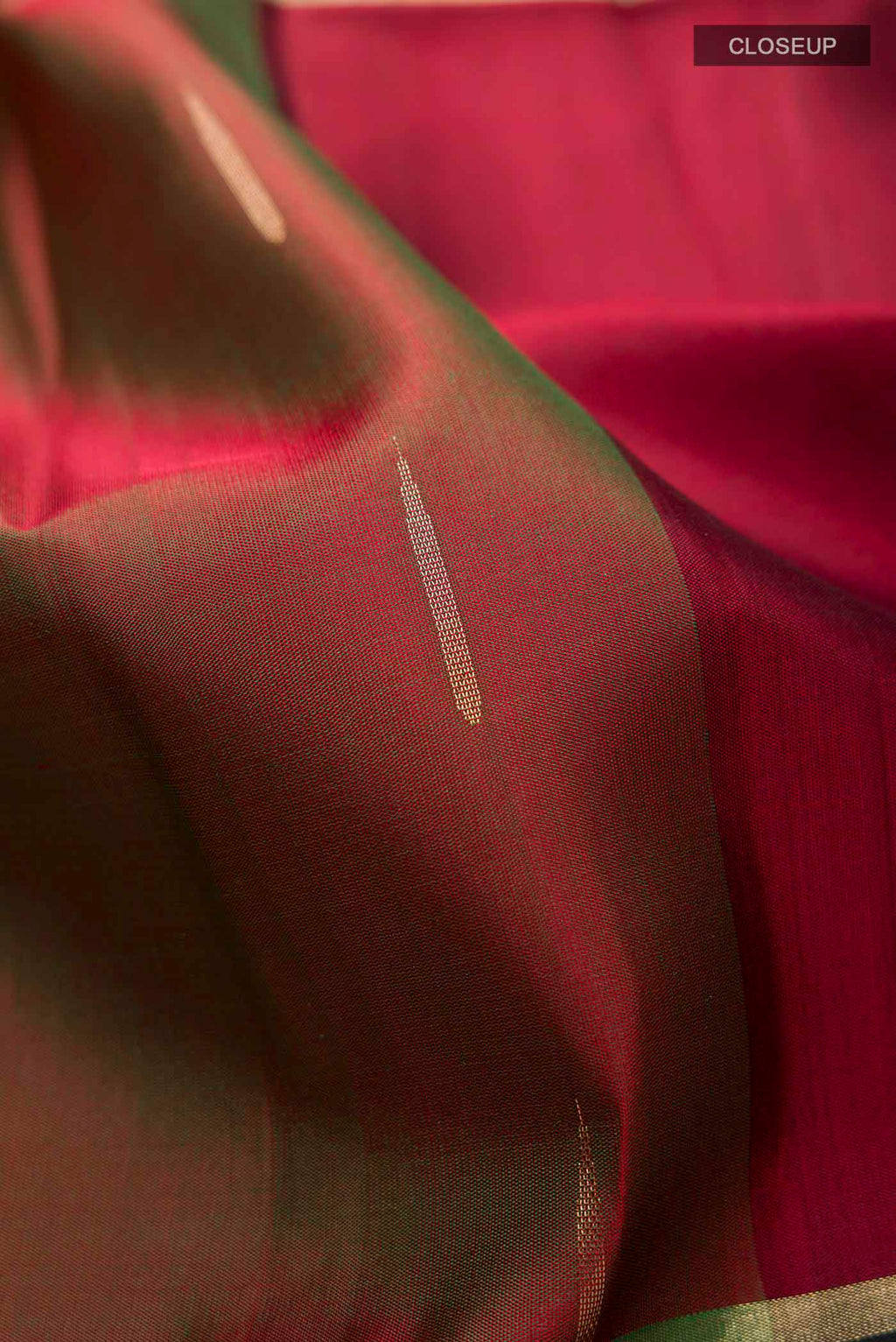 Close up of Green Soft Silk Saree with Zari Butta on the body and Zari Border displaying folds