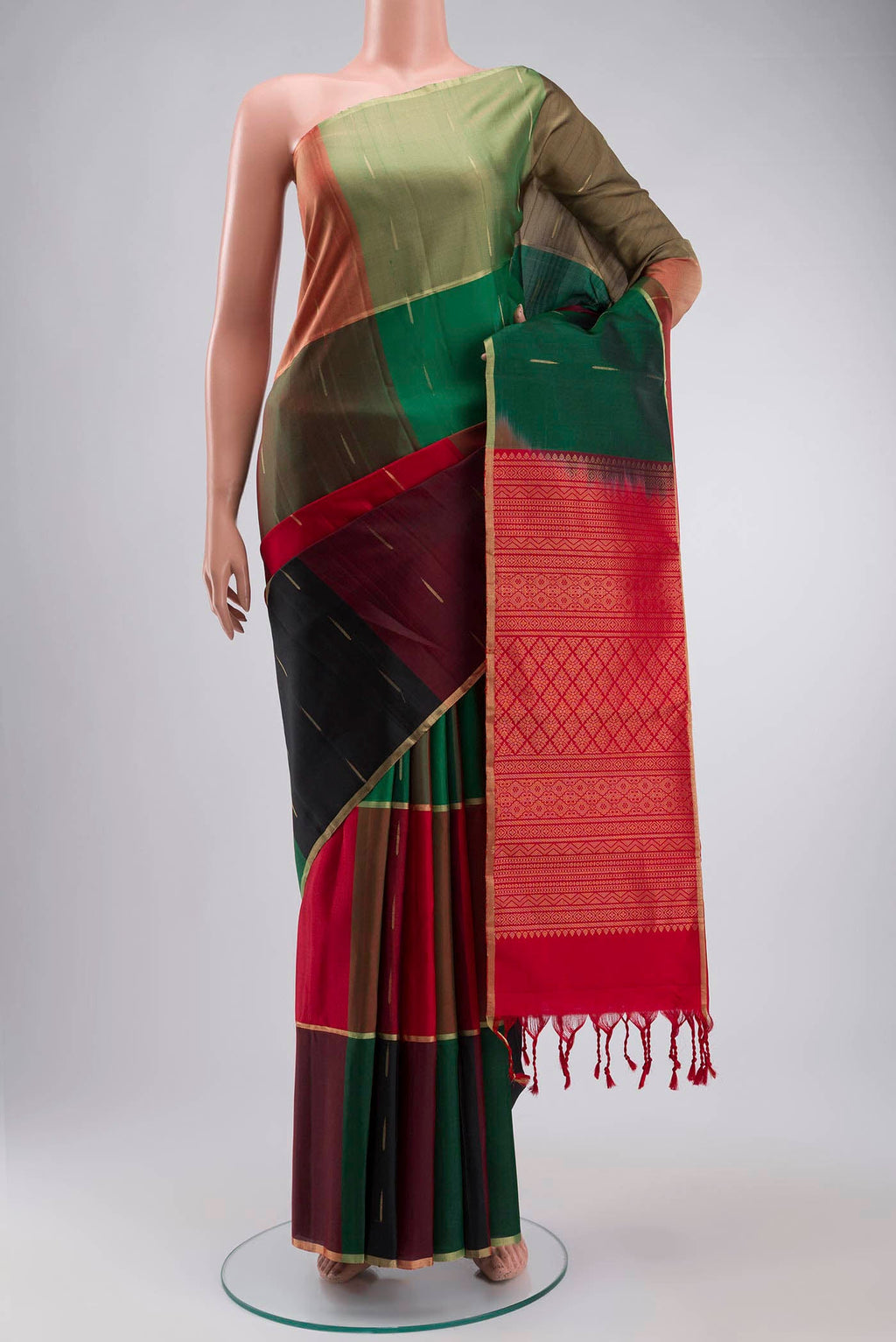 Green Soft Silk Saree with Zari Butta on the body and Zari Border displayed on a mannequin