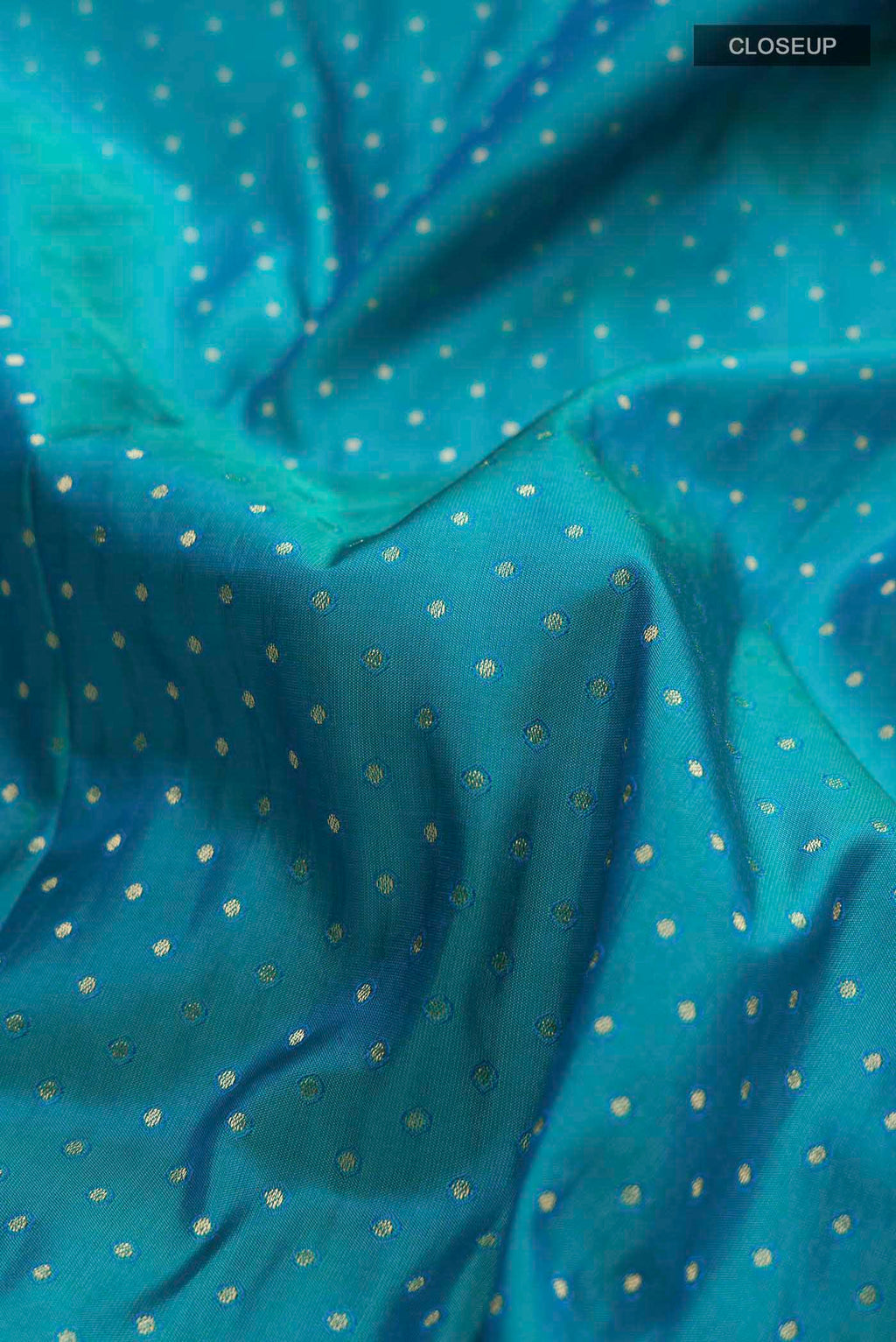 Close up of Blue Soft Silk Saree with Zari Butta on the body and Zari Border displaying folds