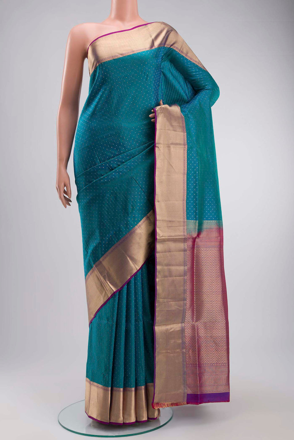 Blue Soft Silk Saree with Zari Butta on the body and Zari Border displayed on a mannequin