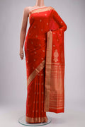 Orange Soft Silk Saree with Zari Butta on the body and Zari Border displayed on a mannequin