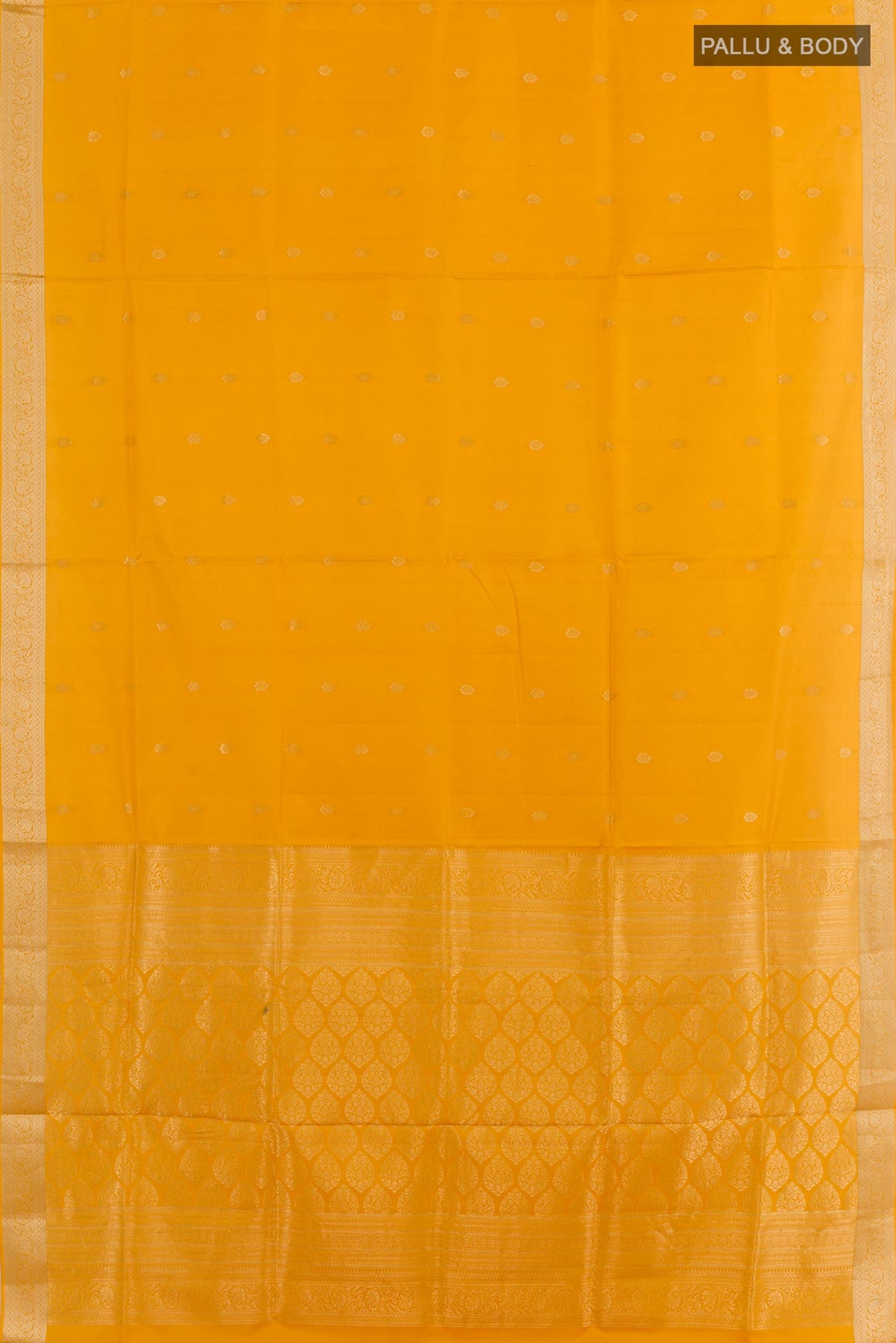 Flat view of Mustard Soft Silk Saree with Zari Butta on the body and Zari Border. 