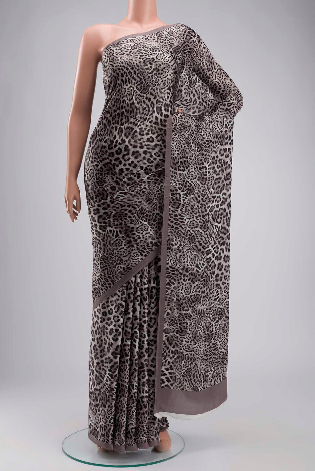 Grey Crepe Saree with Printed design on the body and Plain Border displayed on a mannequin