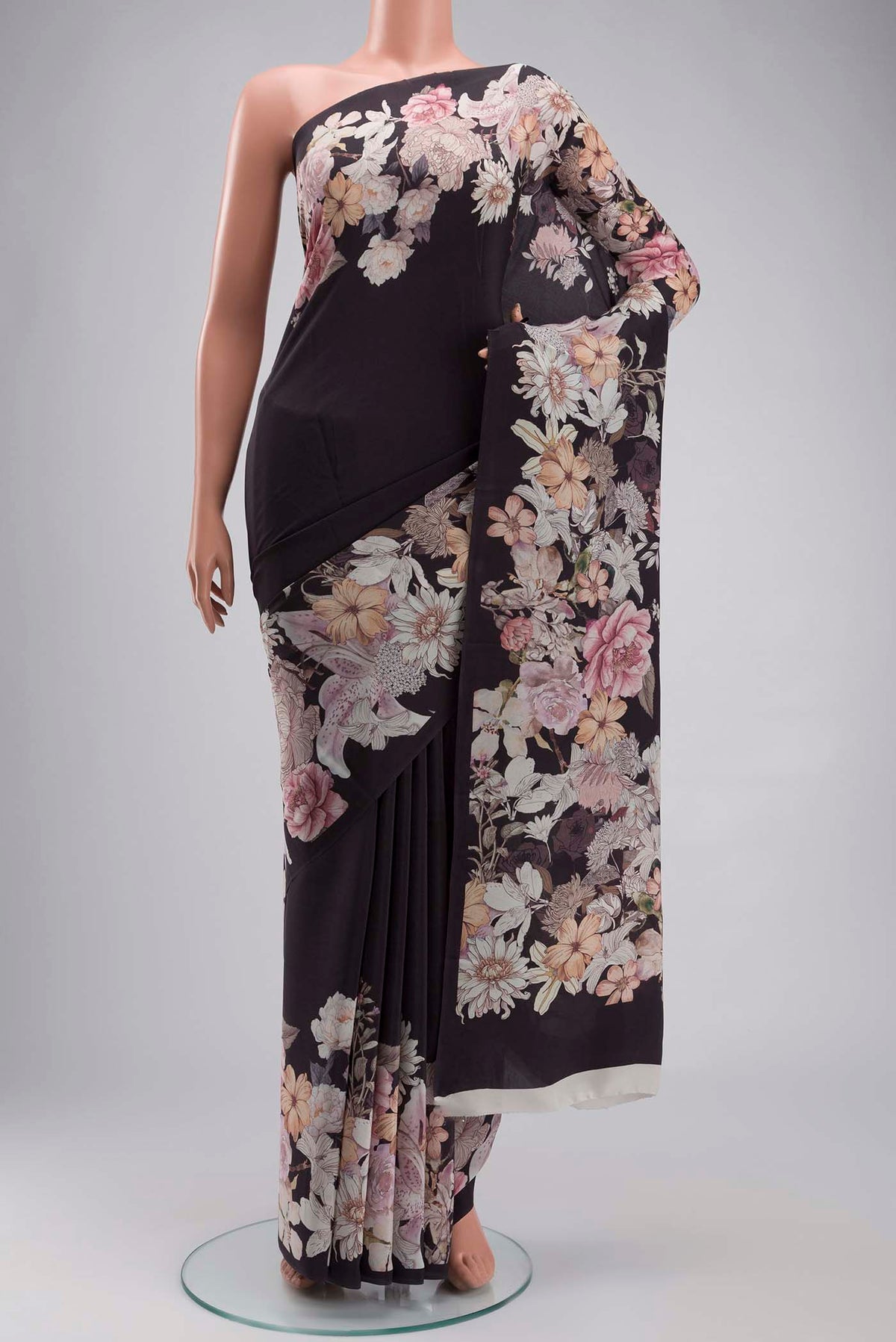 Black Crepe Saree with Printed design on the body and Plain Border displayed on a mannequin