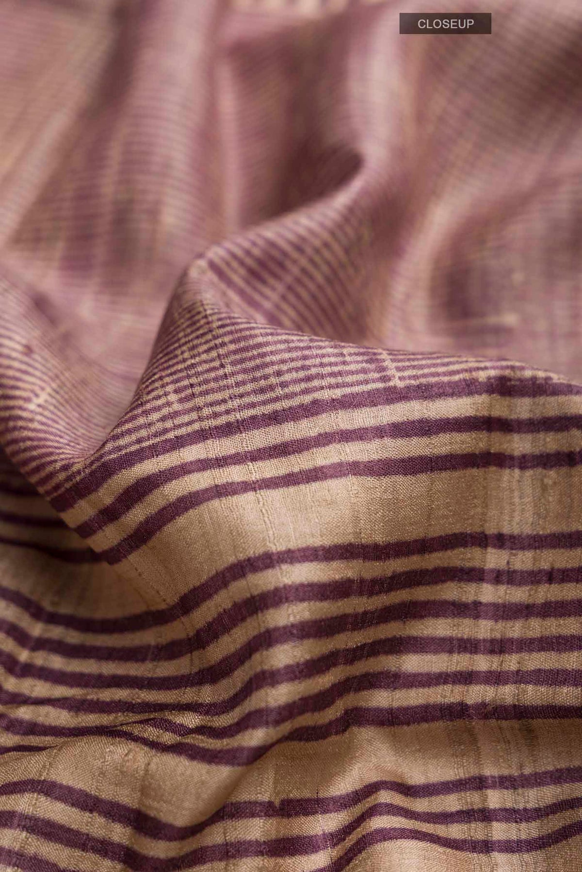Close up of Purple Tussar Silk Saree with Stripes on the body and Temple Border displaying folds