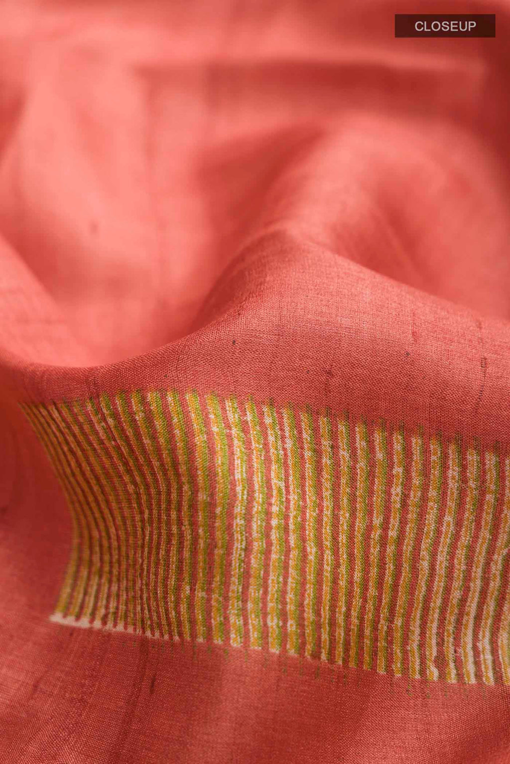 Close up of Rust Bhagalpuri Tussar Silk Saree with Printed design on the body and Plain Border displaying folds