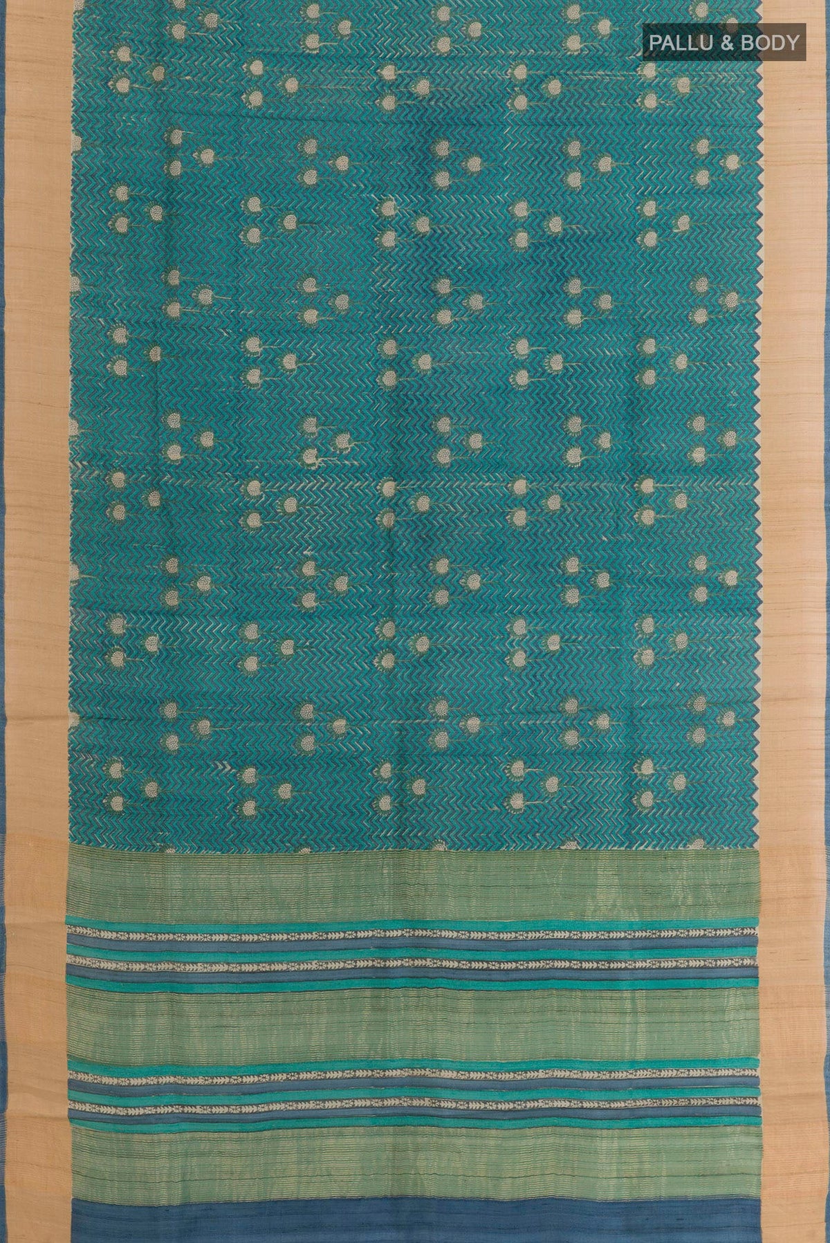 Flat view of Blue Tussar Saree with Printed design on the body and Zari Border. 
