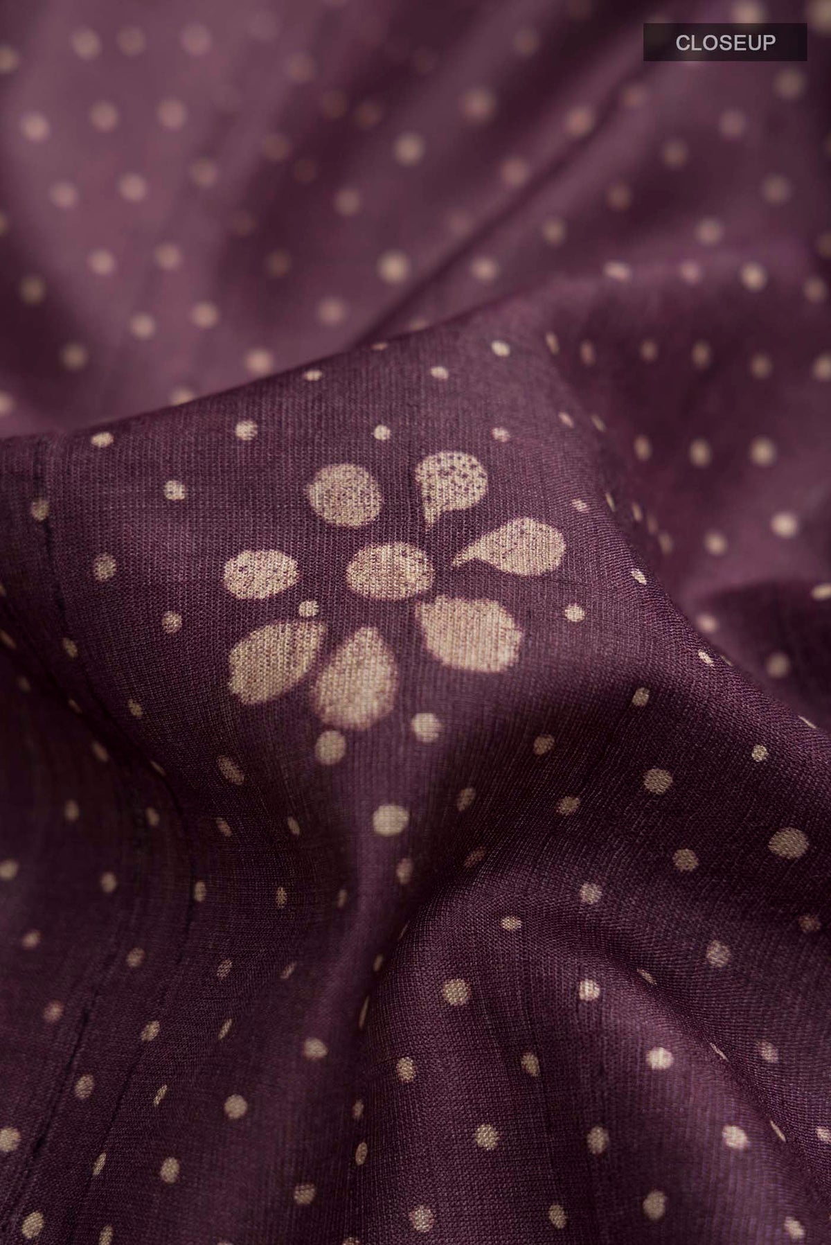 Close up of Purple Tussar Silk Saree with Printed design on the body and Printed Border displaying folds
