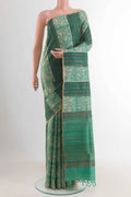 Sea Green Tussar Saree with Printed design on the body and Zari Border displayed on a mannequin