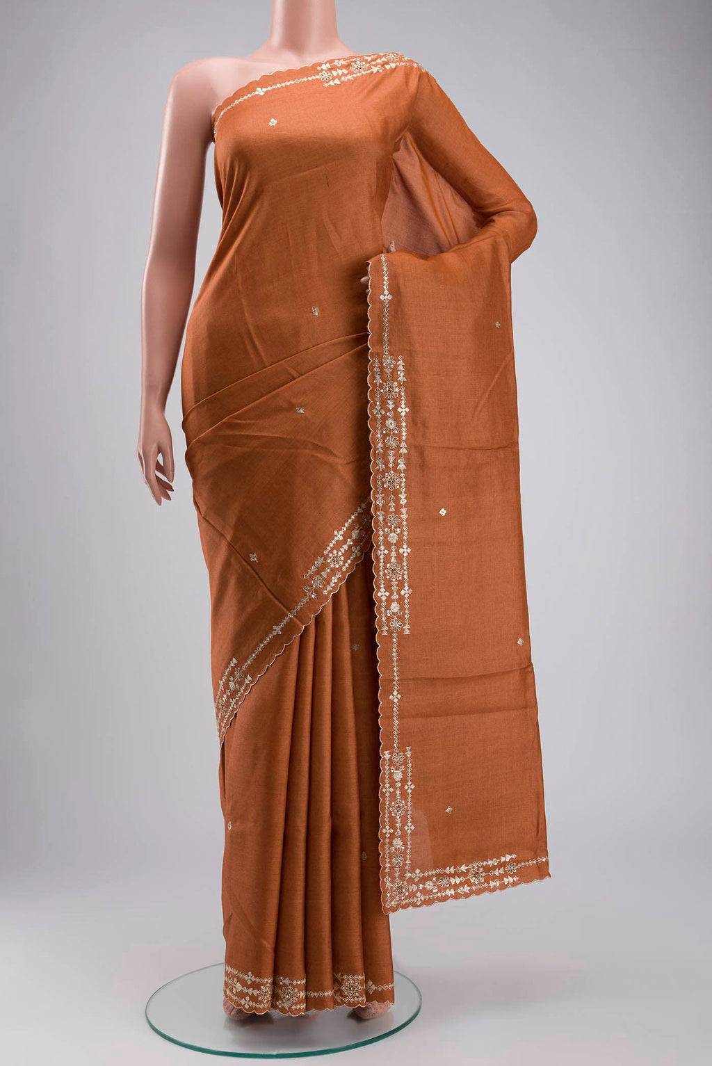 Rust Bhagalpuri Tussar Silk Saree with Embroidery on the body and Embroidery Border displayed on a mannequin