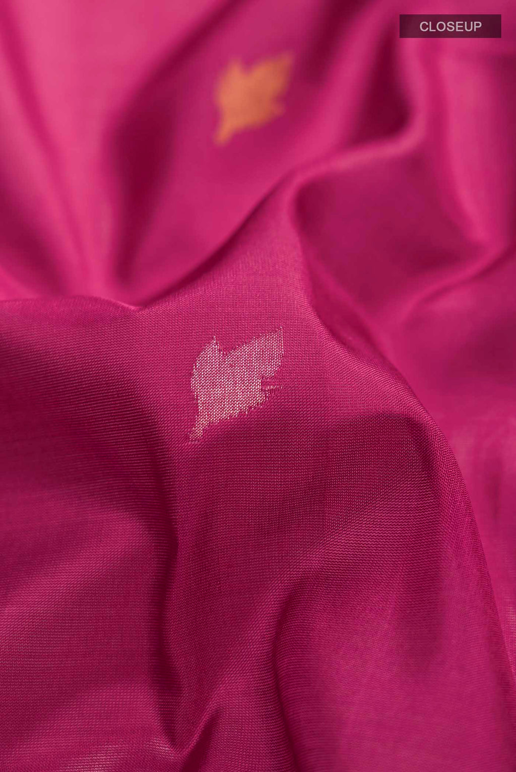 Close up of Pink Uppada Silk Saree with Zari Butta on the body and Zari Border displaying folds
