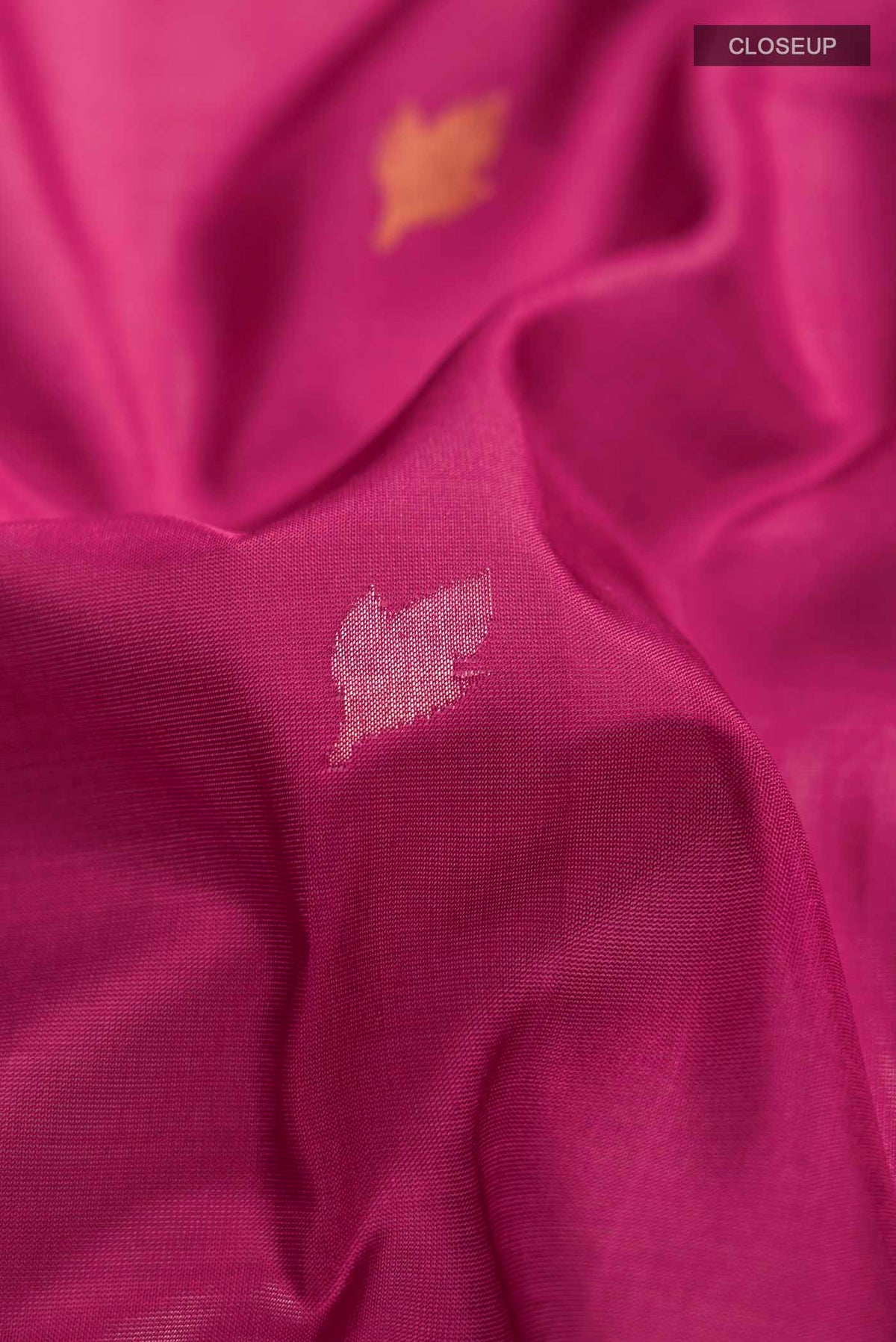 Close up of Pink Uppada Silk Saree with Zari Butta on the body and Zari Border displaying folds