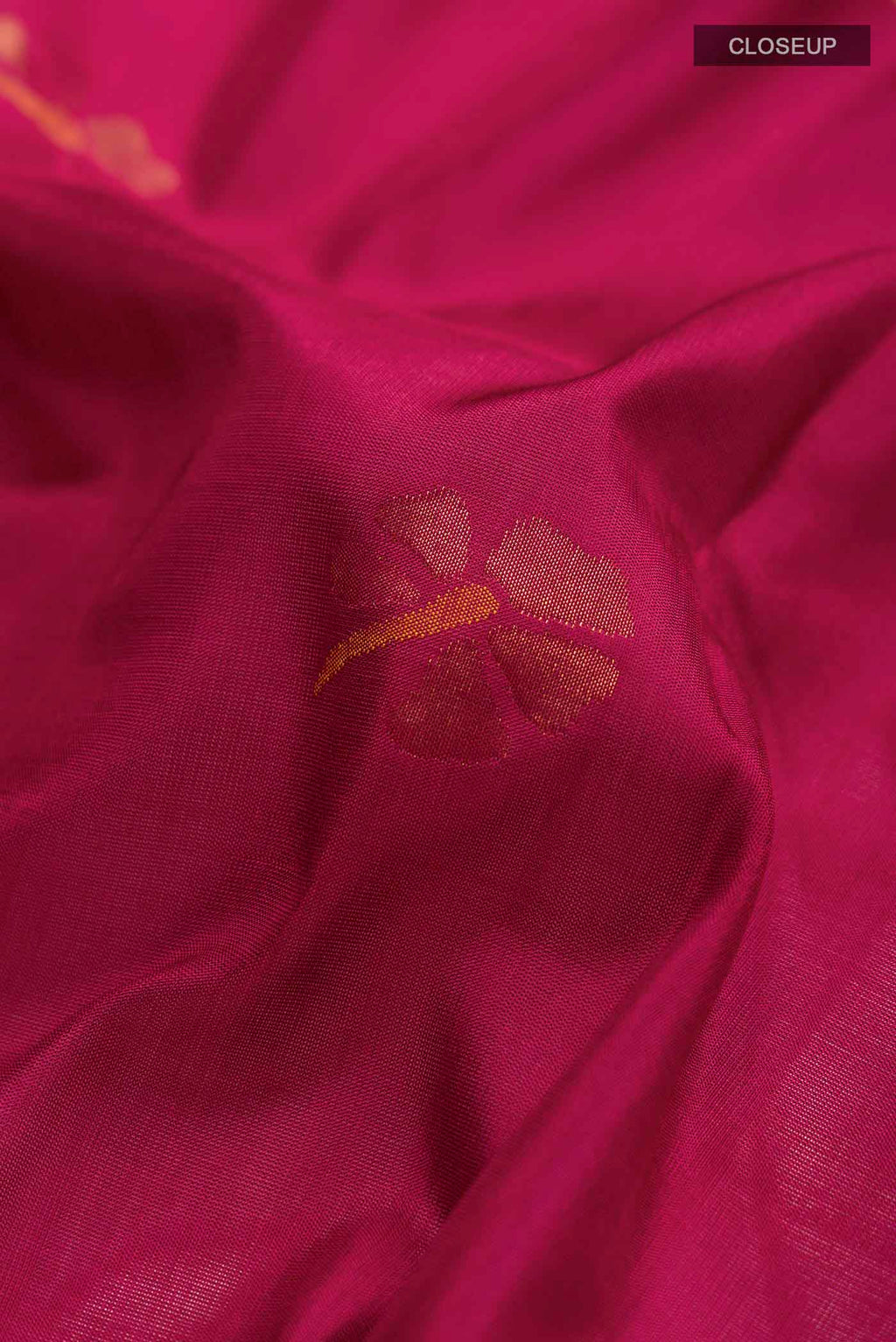 Close up of Maroon Uppada Silk Saree with Zari Butta on the body and Zari Border displaying folds