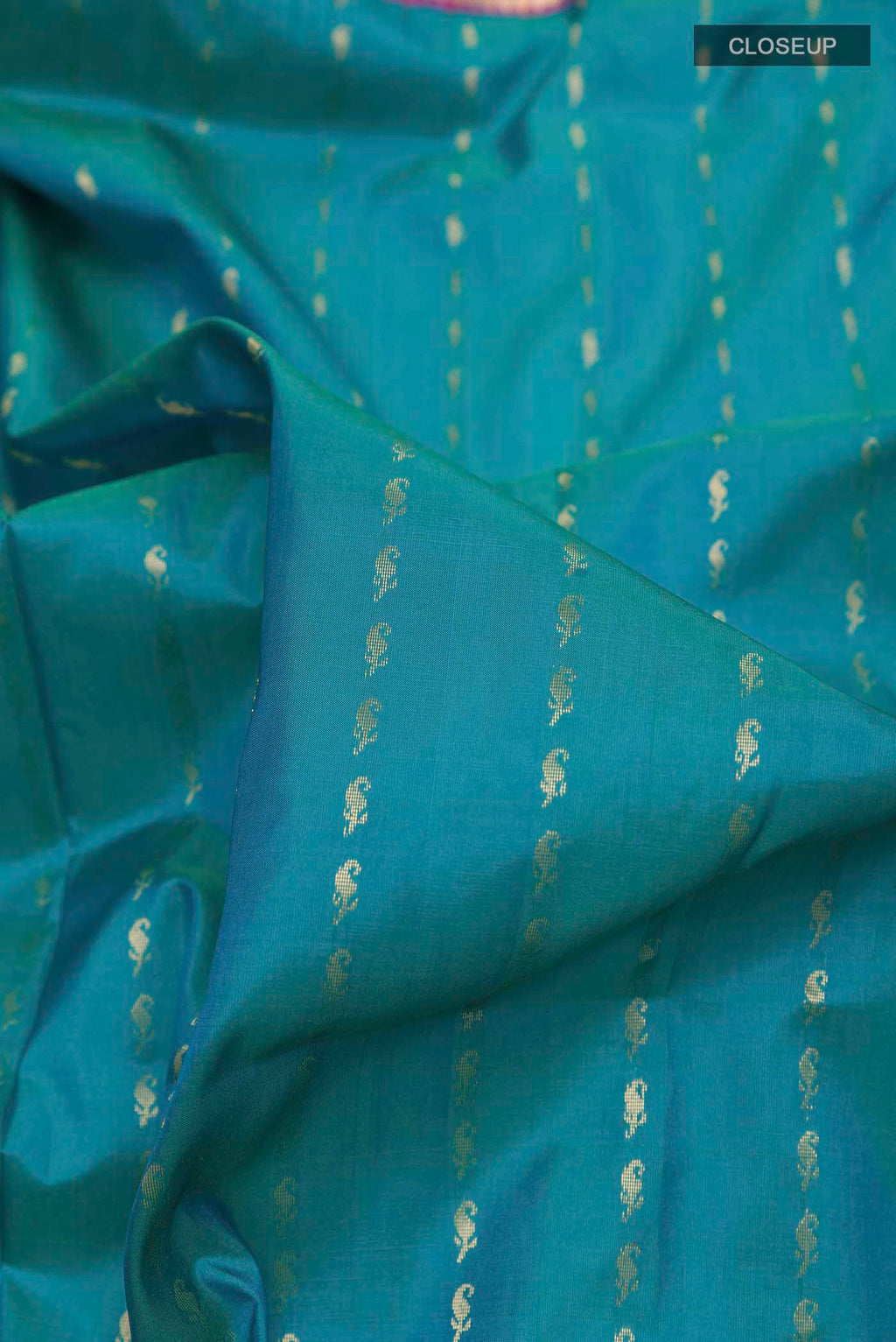 Close up of Blue Soft Silk Saree with Stripes on the body and Zari Border displaying folds