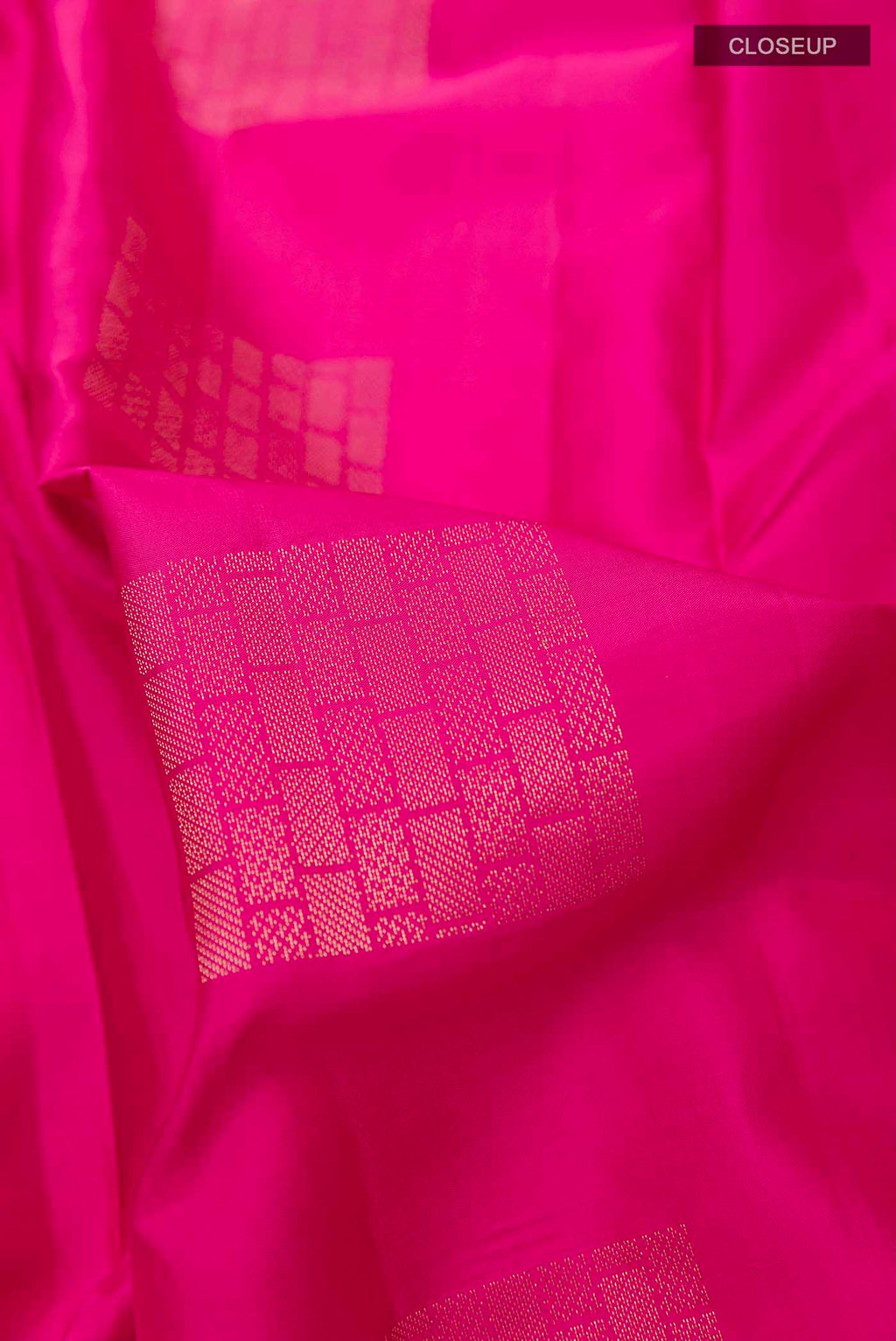Close up of Pink Soft Silk Saree with Zari Butta on the body and Without Border displaying folds