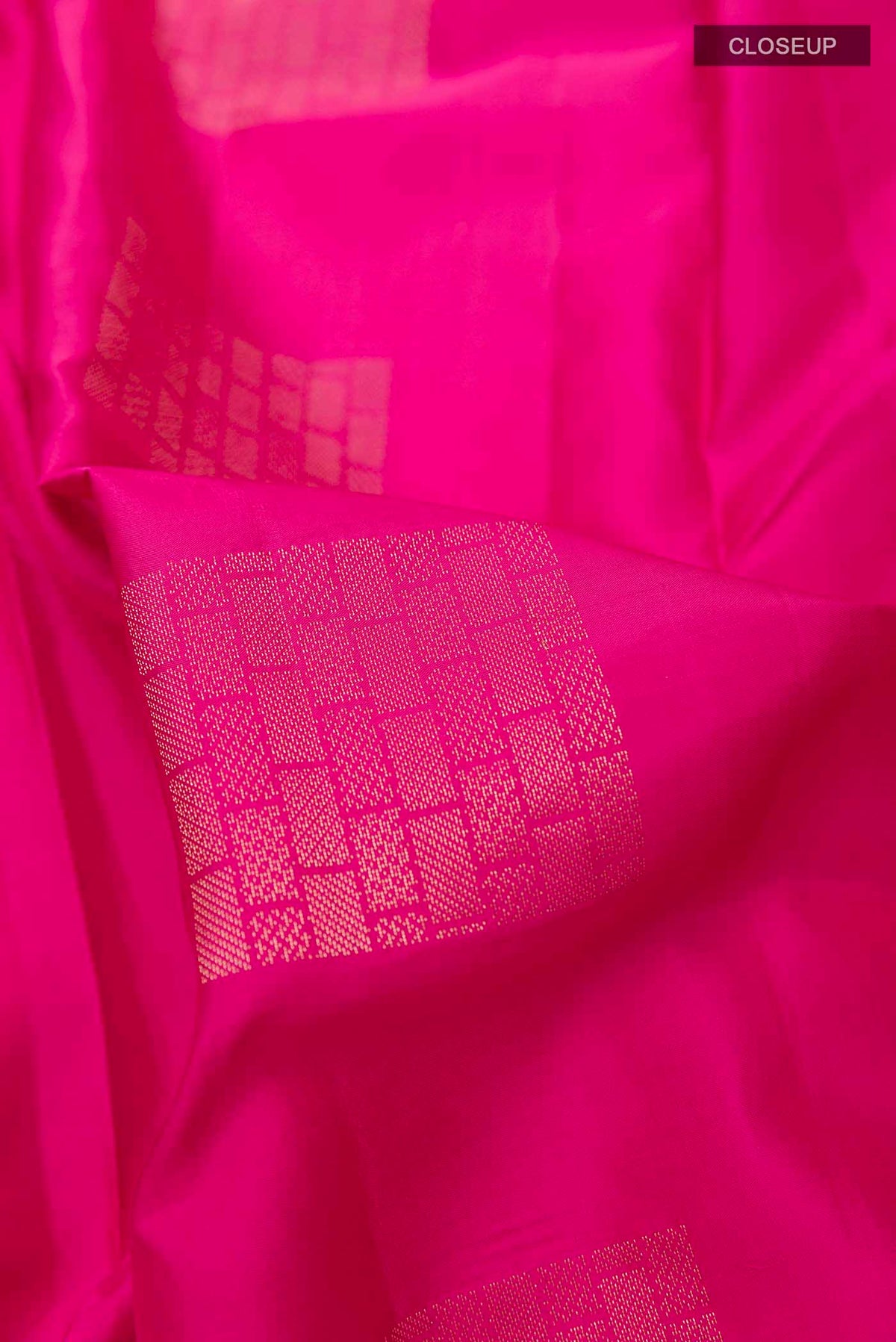 Close up of Pink Soft Silk Saree with Zari Butta on the body and Without Border displaying folds