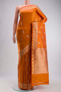 Orange Banarasi Katan Silk Saree with Zari Butta on the body and Zari Border displayed on a mannequin