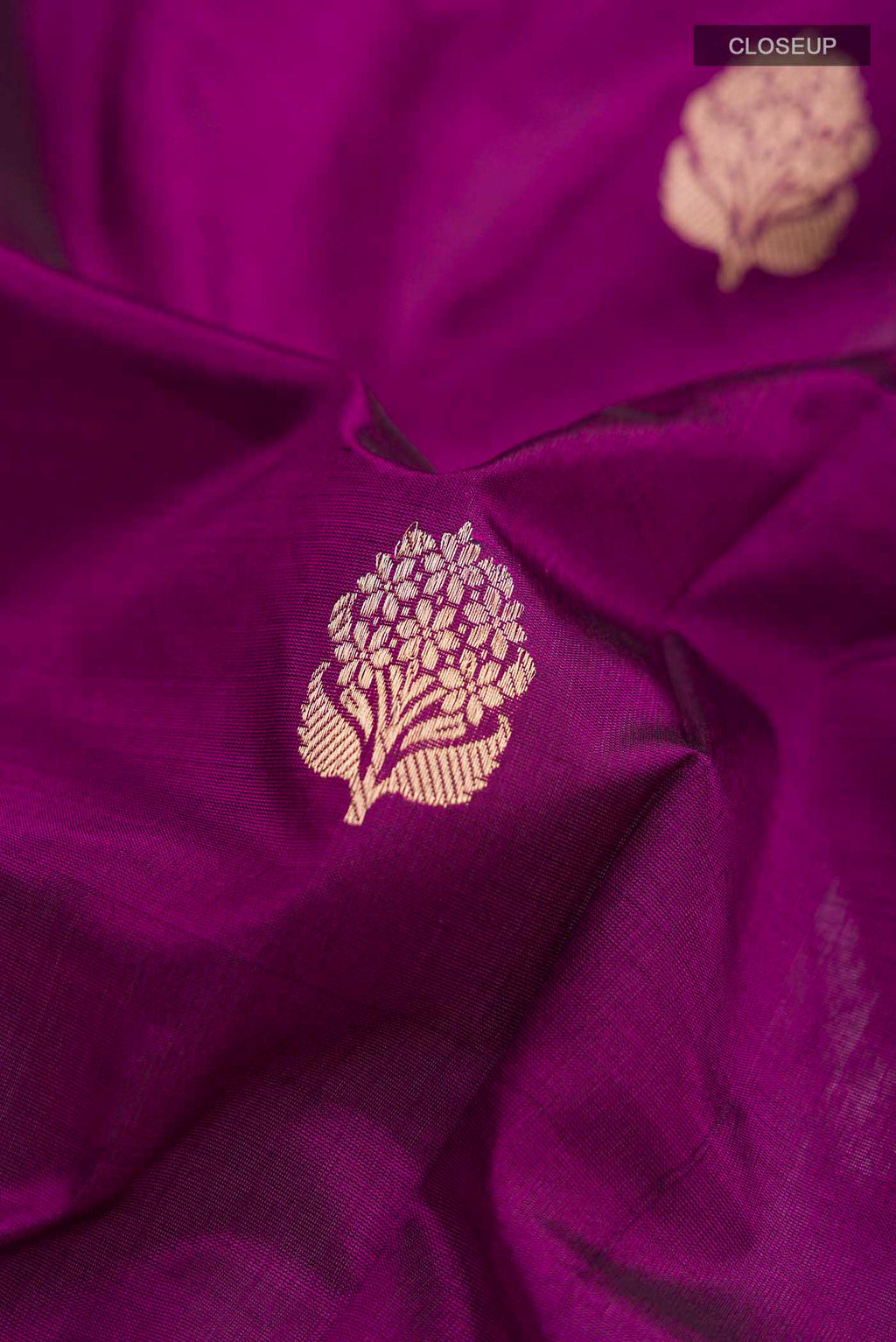 Close up of Violet Banarasi Katan Silk Saree with Zari Butta on the body and Zari Border displaying folds