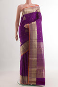 Purple Kanjivaram Silk Saree with Zari Butta on the body and Zari Border.  displayed on a mannequin
