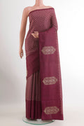 Magenta Tussar Silk Saree with Printed design on the body and Zari Border.  displayed on a mannequin