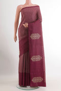 Magenta Tussar Saree with Printed design on the body and Zari Border.  displayed on a mannequin