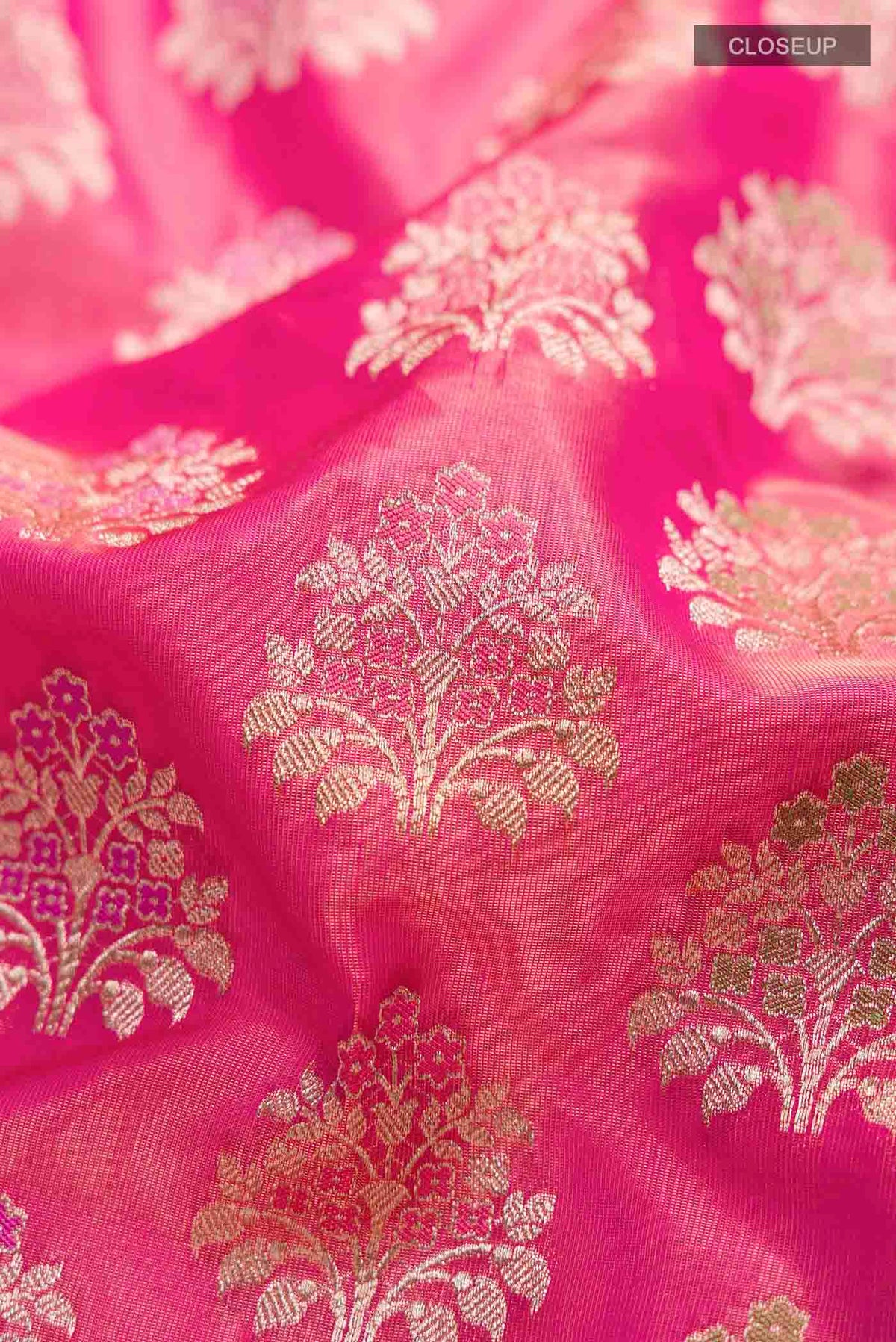 Close up of Pink Banarasi Silk Saree with Zari Butta on the body and Zari Border displaying folds