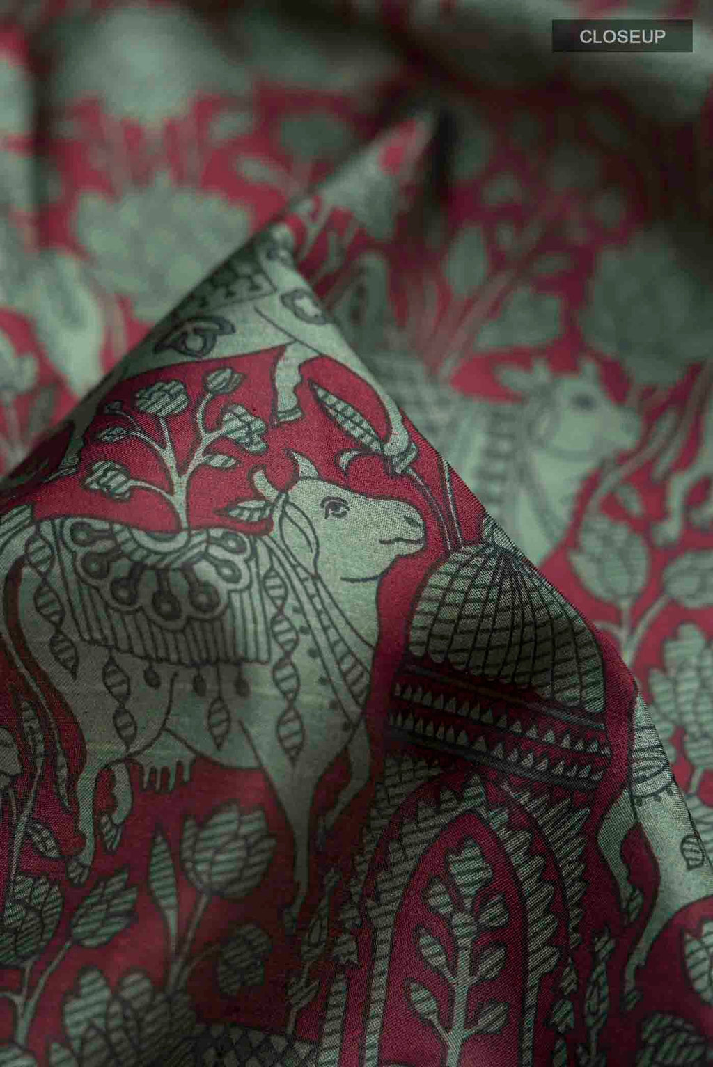 Close up of Maroon Printed Silk Saree with Printed design on the body and Plain Border displaying folds