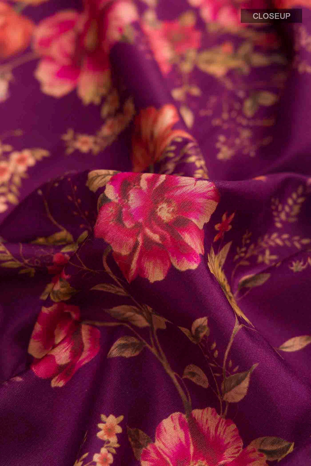 Close up of Magenta Printed Silk Saree with Printed design on the body and Zari Border displaying folds