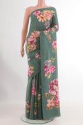 Blue Grey Crepe Saree with Printed design on the body and Printed Border.  displayed on a mannequin