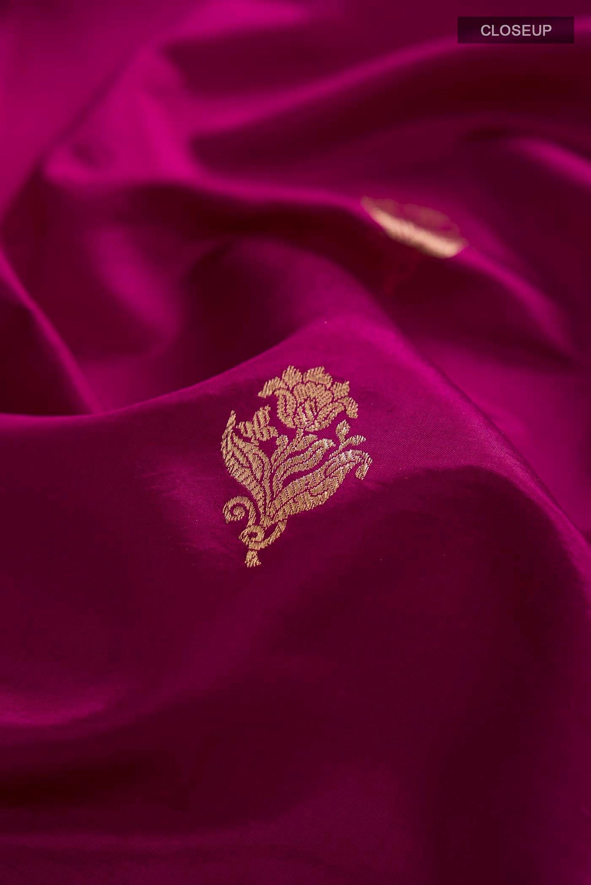 Close up of Purple Banarasi Katan Silk Saree with Zari Butta on the body and Zari Border displaying folds
