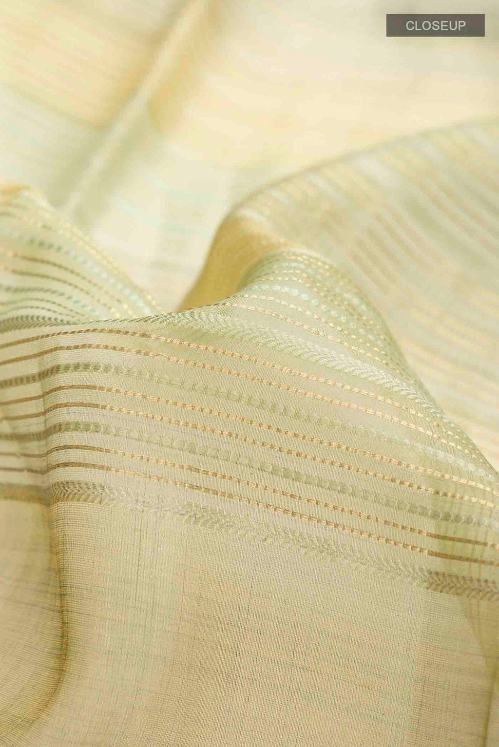 Close up of Green Tussar Silk Saree with Stripes on the body and Satin Border displaying folds