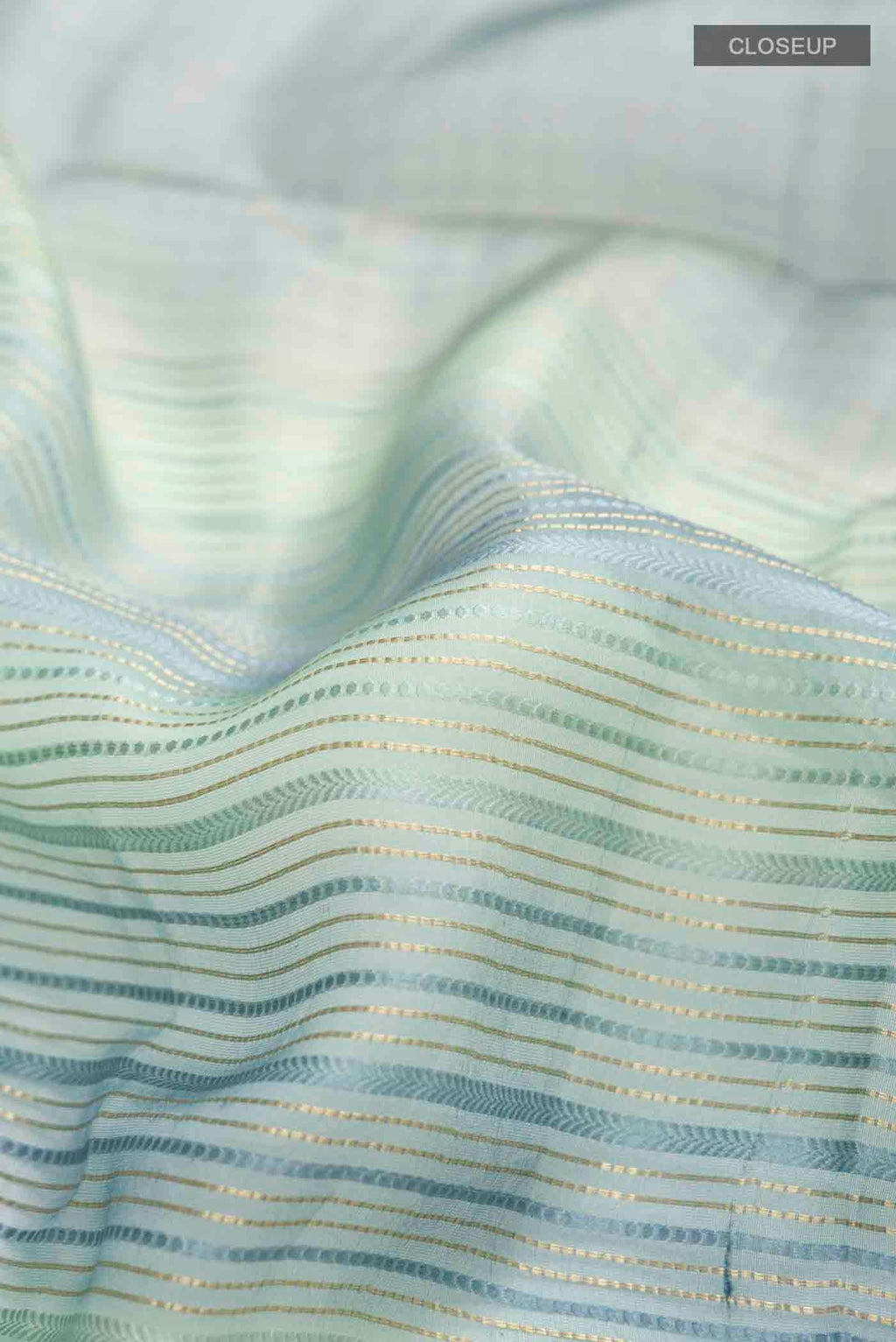 Close up of Blue Tussar Silk Saree with Stripes on the body and Zari Border displaying folds