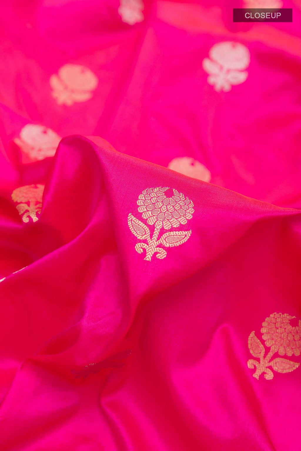 Close up of Pink Banarasi Silk Saree with Zari Butta on the body and Zari Border displaying folds