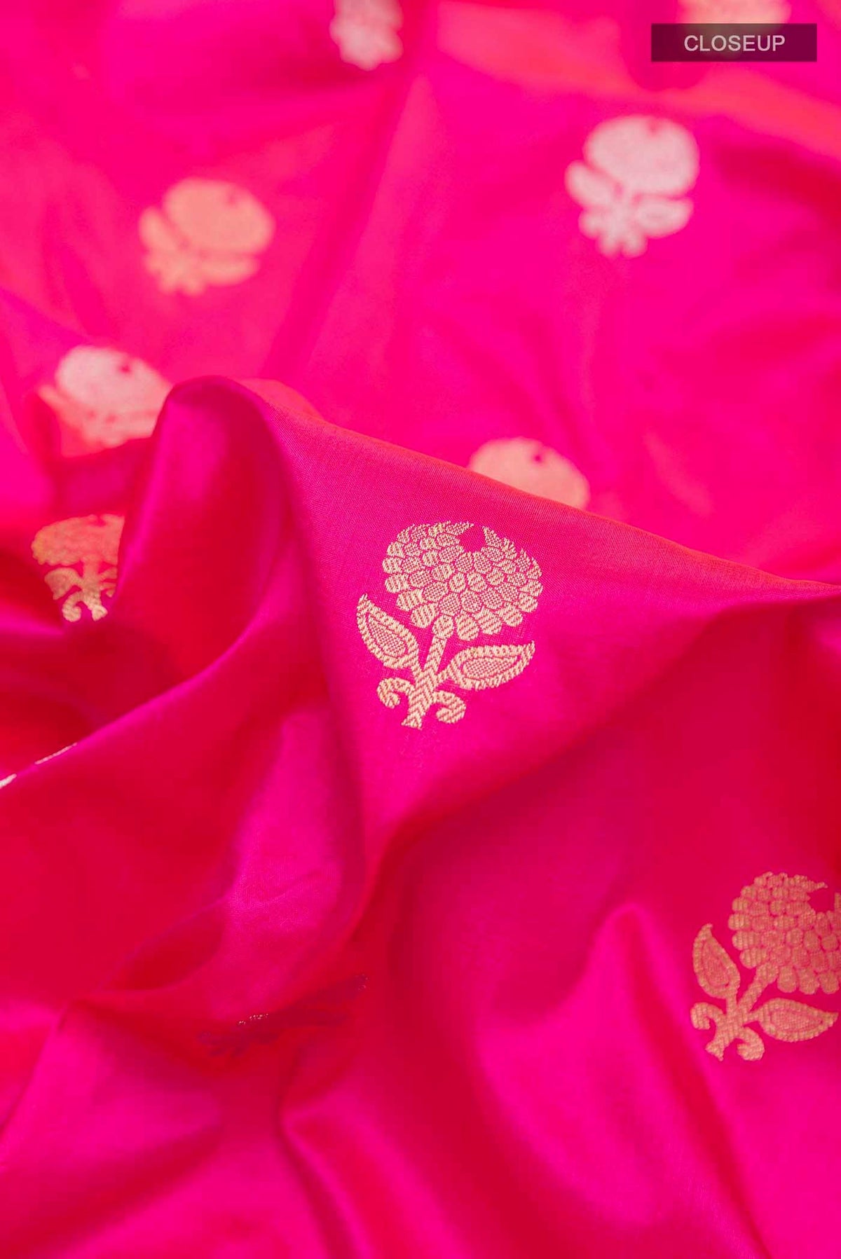 Close up of Pink Banarasi Silk Saree with Zari Butta on the body and Zari Border displaying folds