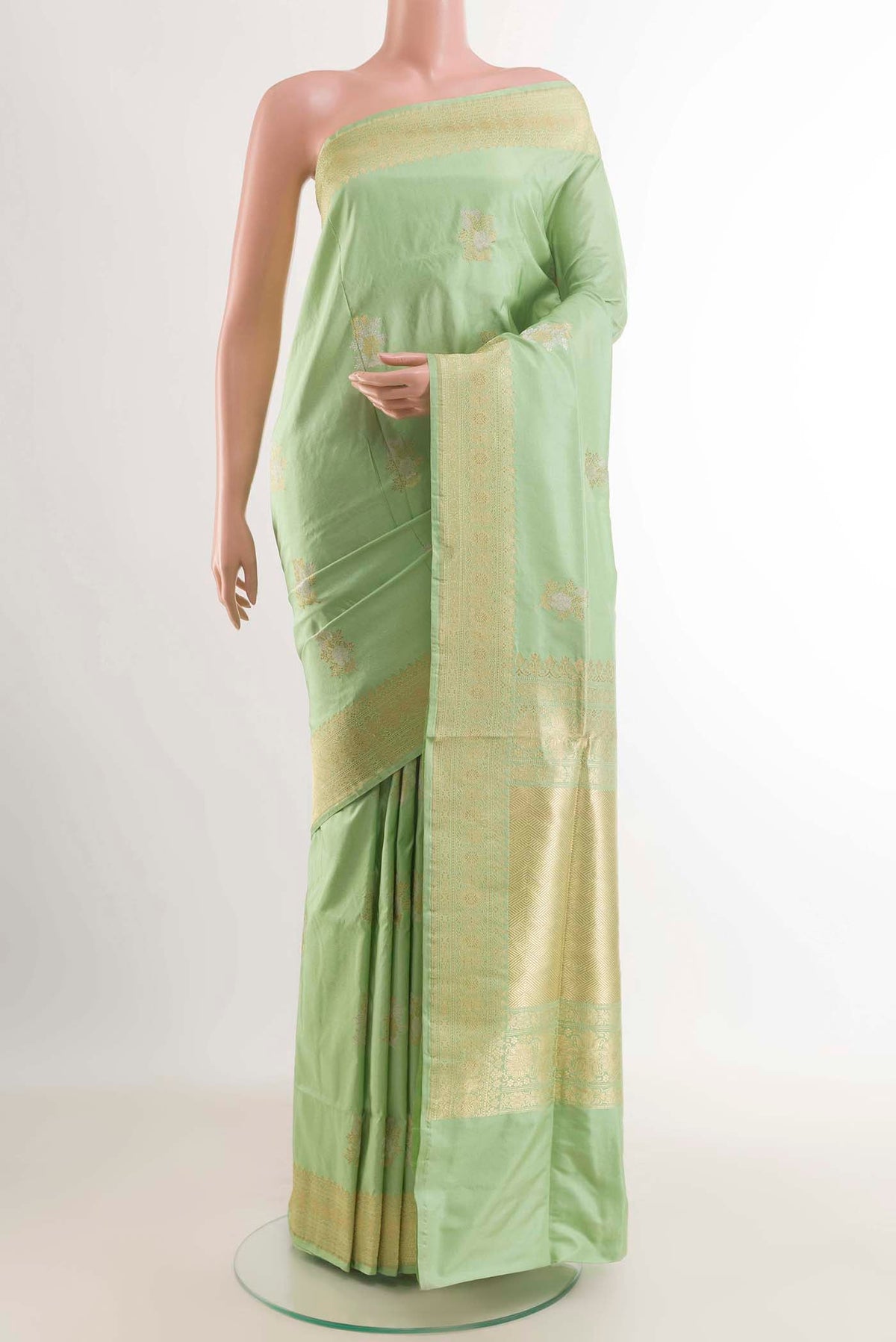 Green Banarasi Silk Saree with Zari Butta on the body and Zari Border displayed on a mannequin