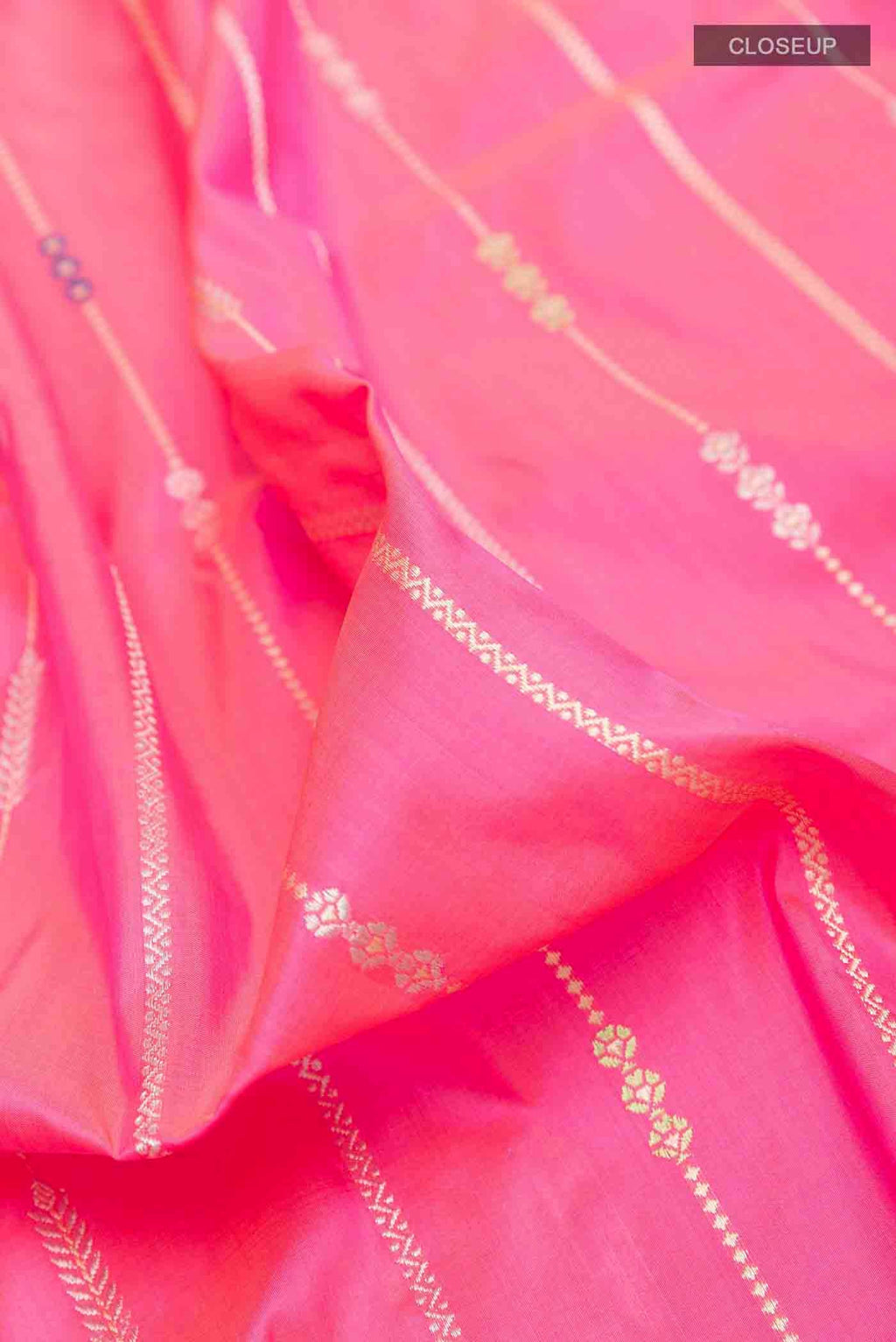 Close up of Pink Banarasi Silk Saree with Stripes on the body and Zari Border displaying folds