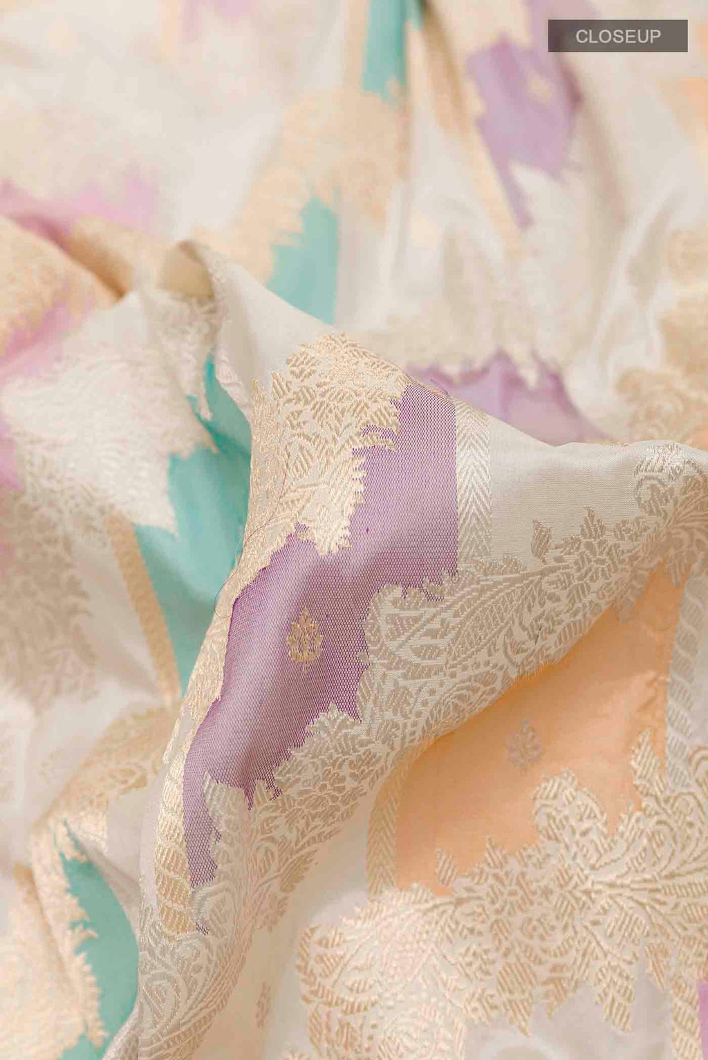 Close up of Off White Banarasi Silk Saree with Zari Brocade on the body and Zari Border displaying folds