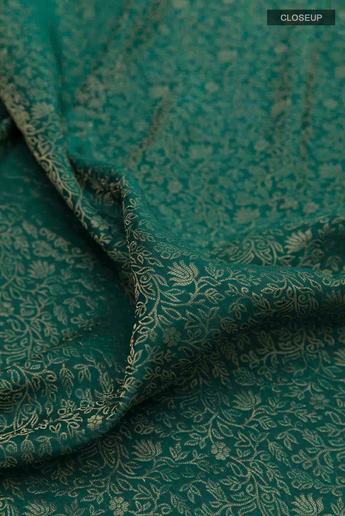 Close up of Green Mysore Crepe Saree with Zari Brocade on the body and Zari Border displaying folds