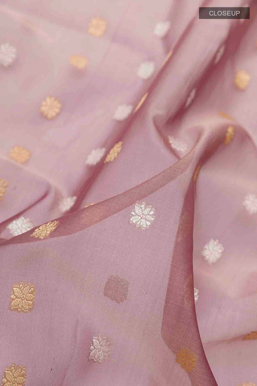 Close up of Mauve Banarasi Kora Silk Saree with Zari Butta on the body and Zari Border displaying folds