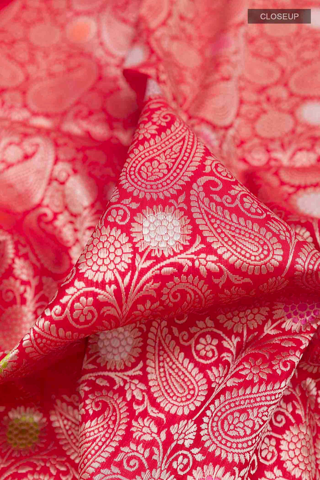 Close up of Pink Banarasi Silk Saree with Zari Butta on the body and Zari Border displaying folds