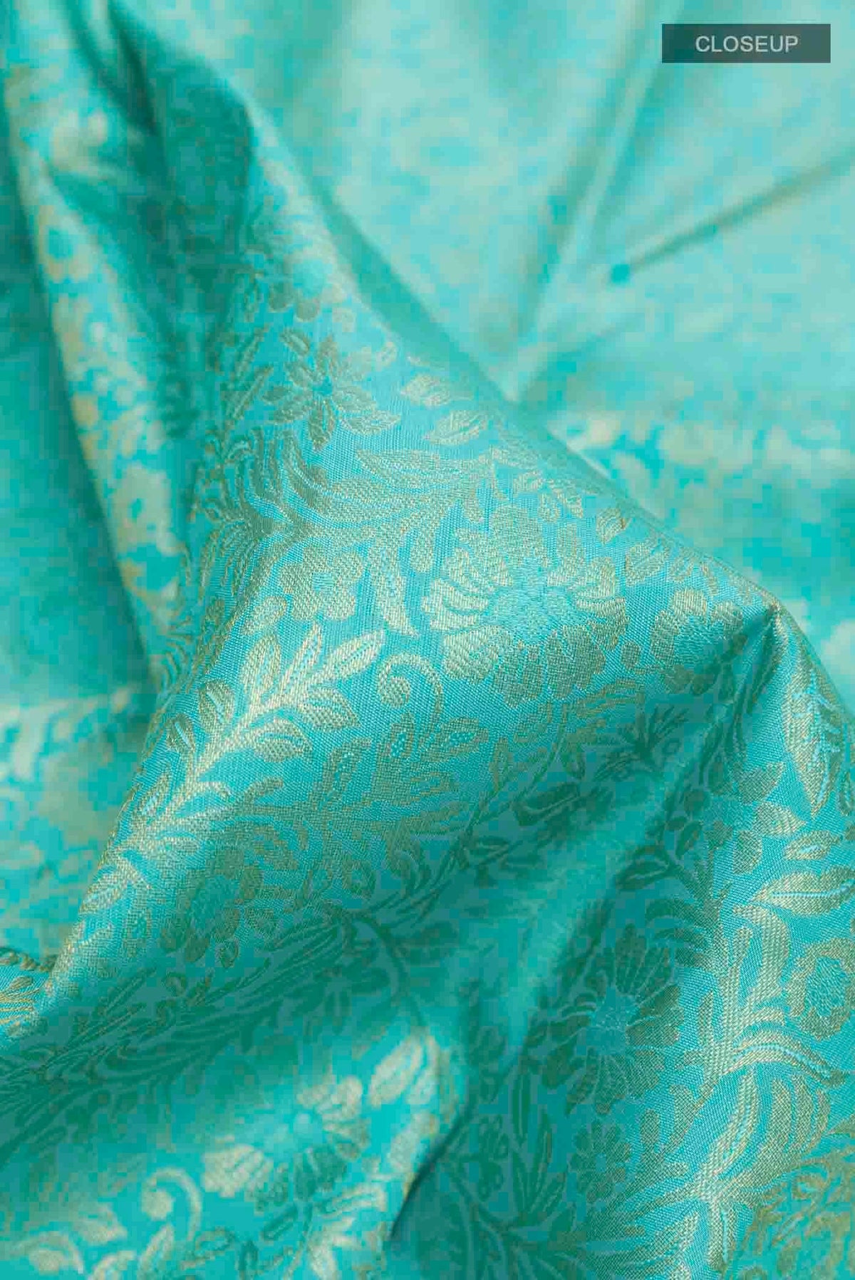 Close up of Pure Silk Pure Zari Sky Blue Kanchipuram Saree with Zari Brocade on the body and Zari Border displaying folds