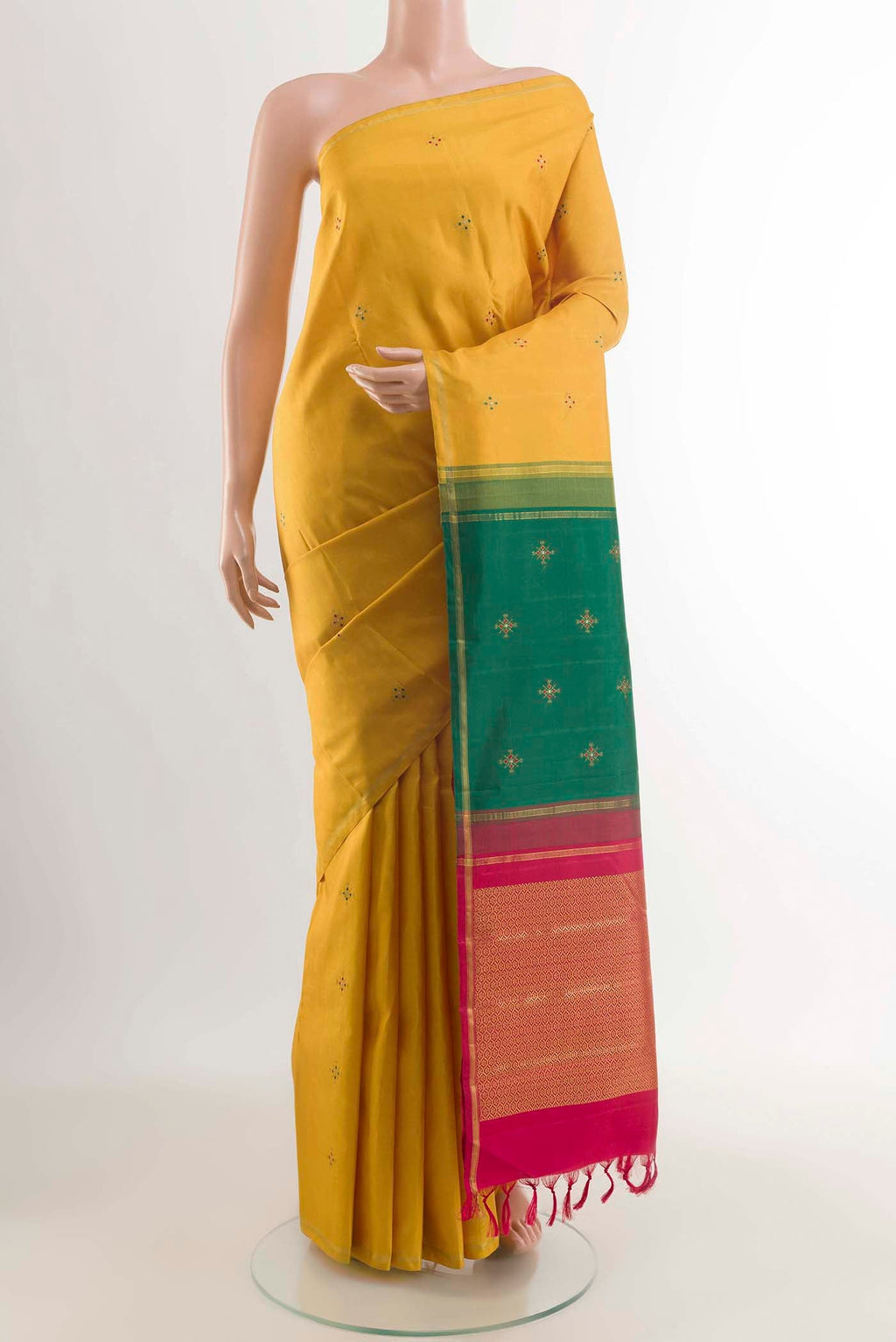 Mustard Kanchipuram Silk Saree with Zari Butta on the body and Zari Border displayed on a mannequin