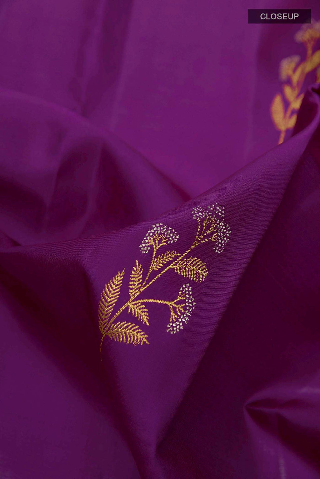 Close up of Dark Blue Kanchipuram Silk Saree with Zari Butta on the body and Zari Border displaying folds